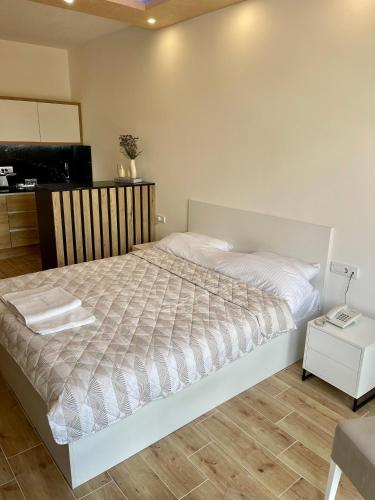 a bedroom with a large bed and a television at Apartmani Vidikovac in Prijepolje