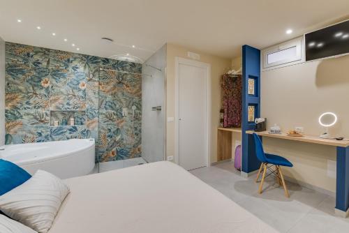 a bedroom with a white bed and a blue wall at !!! IDROMASSAGGIO !!! - Love Suite in Sciacca