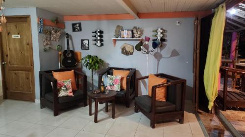 a living room with two chairs and a table at Villa Rosa in Punta Rucia