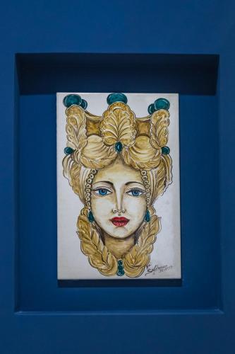 a drawing of a woman in a blue frame at !!! IDROMASSAGGIO !!! - Love Suite in Sciacca