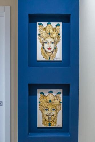 two framed paintings of a woman in a blue door at !!! IDROMASSAGGIO !!! - Love Suite in Sciacca