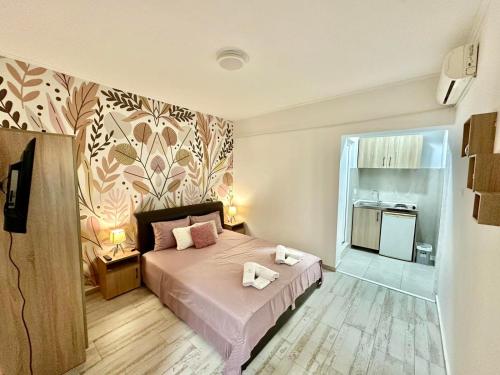 a bedroom with a bed with two towels on it at City center in Ulcinj