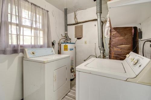 a laundry room with a washer and dryer at Garden City Home with Screened Porch Near Savannah! in Savannah