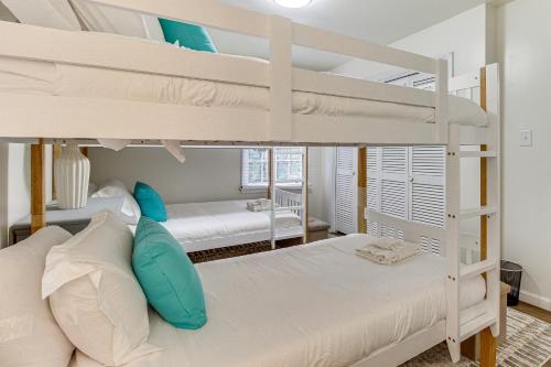 a bedroom with two bunk beds in a house at Garden City Home with Screened Porch Near Savannah! in Savannah