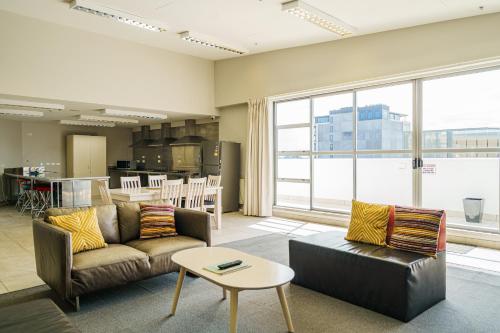 a living room with a couch and a table at Ibis Styles Invercargill in Invercargill