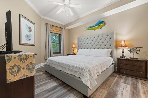 a bedroom with a large bed and a television at Phoenix On The Bay 1108 by Vacation Homes Collection in Orange Beach