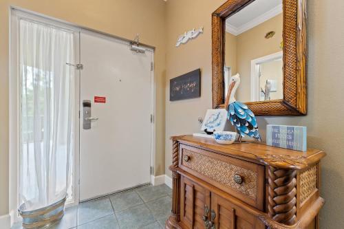 a bathroom with a mirror and a wooden dresser at Phoenix On The Bay 1108 by Vacation Homes Collection in Orange Beach