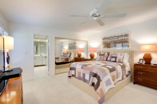 a bedroom with a bed and a dresser and a tv at Sunny Palm Springs Haven Fenced Patio, 6 Pools! in Palm Springs