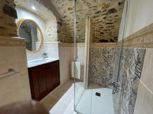 a bathroom with a shower and a sink at Can Garriga in Garriguella