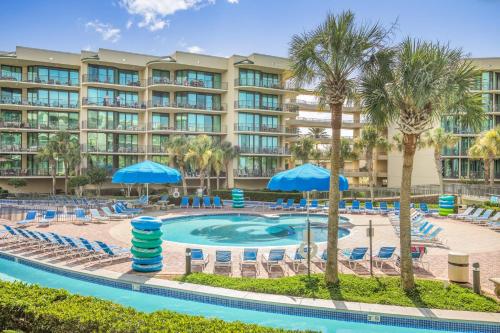 an image of a resort pool with chairs and umbrellas at Phoenix On The Bay 1108 by Vacation Homes Collection in Orange Beach