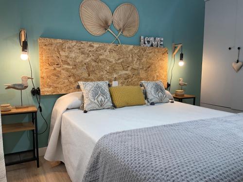 a bedroom with a large bed with a large headboard at MiraSierraHome... Tú hogar de vacaciones! in Alora