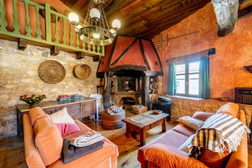a living room with a couch and a fireplace at Hostel INpulso Atapuerca in Atapuerca