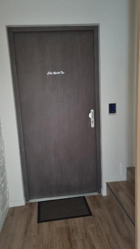 a large door in a room with a wooden floor at CDG Aparts in Le Mesnil-Amelot