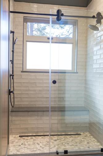 a shower with a glass door in a bathroom at Firefall Ranch Yosemite in Groveland