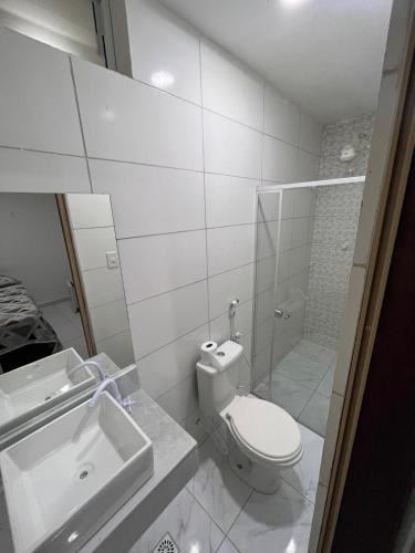 a bathroom with a toilet and a sink and a shower at Suite Em Maragogi (pousada) in Maragogi