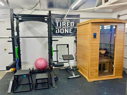 a gym with a squat rack and a tread machine at Rose Garden Home, Entire 4bdr 2bth House with Offices, Thousand Oaks in Thousand Oaks