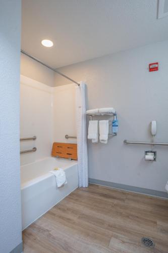 a bathroom with a bath tub and a sink at Microtel Inn & Suites by Wyndham Albertville in Albertville