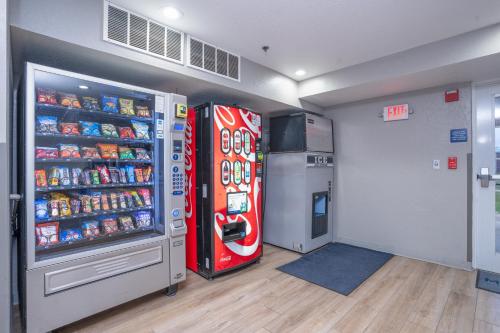 a room with a red refrigerator next to a freezer at Microtel Inn & Suites by Wyndham Albertville in Albertville