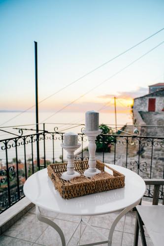 a table with two candles on top of a balcony at The Traditional House of Molivos in Mithymna