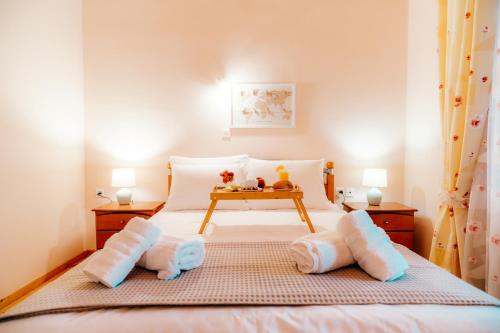 a bedroom with a bed with pillows and a table at The Traditional House of Molivos in Mithymna