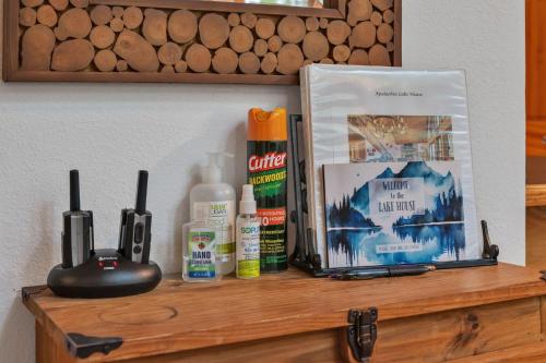 a shelf with a book and other products on it at Lakefront Cabin Bordering Nat Park with Hot Tub! cabin in Turtletown