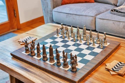 a chess board on a table in a living room at Lakefront Cabin Bordering Nat Park with Hot Tub! cabin in Turtletown