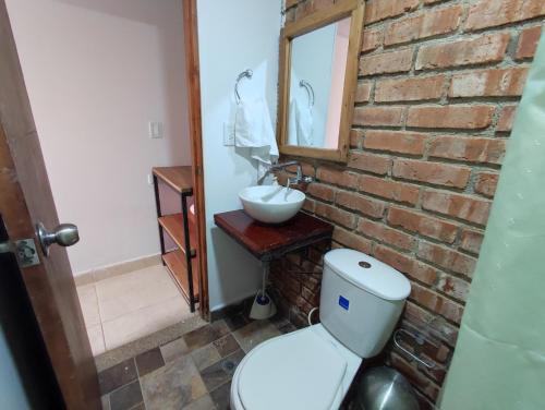 a bathroom with a white toilet and a sink at Casa Buenavista in Buenavista