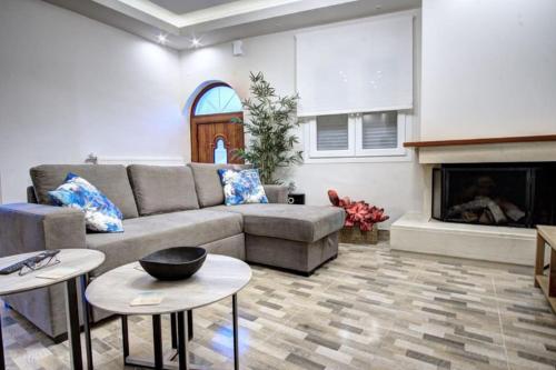 a living room with a couch and a fireplace at AnGio City House in Análipsis