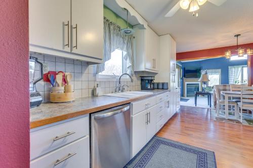 a large kitchen with white cabinets and a sink at Prairie du Chien Home with Yard 3 Mi to River! in Prairie du Chien