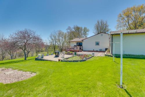 a yard with a white house and a yard at Prairie du Chien Home with Yard 3 Mi to River! in Prairie du Chien