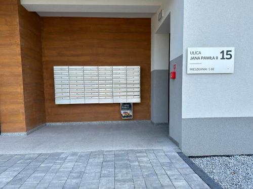 a wooden door with a window in a building at Apartament Perła - Zator Energylandia in Zator