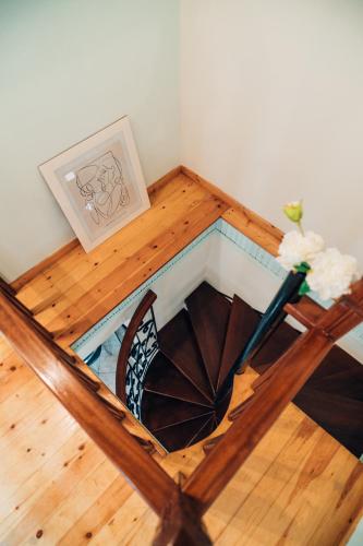a spiral staircase in a room with a wooden floor at The Traditional House of Molivos in Mithymna