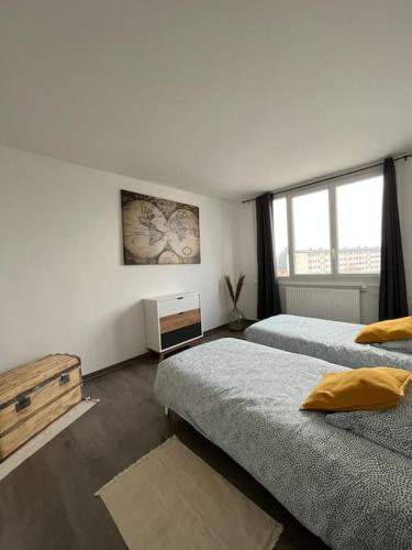 une chambre avec deux lits et une fenêtre dans l'établissement Le grand arc, proche centre ville, à Albertville