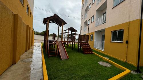 a playground in an apartment building with a slide at Cantinho de paz in Santarém
