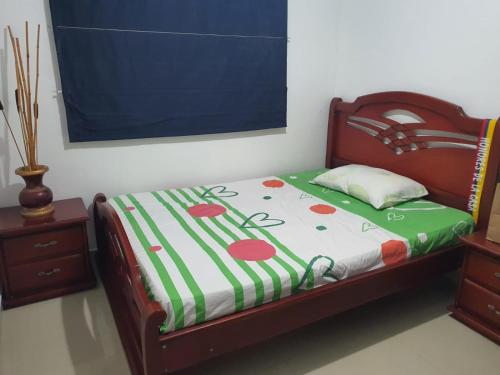 a bed in a room with avertisement at Apto Torres de Montreal in Barranquilla