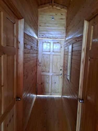 a wooden hallway with a door in a room at Cabaña Cebra - THE Spot for GREAT Sunset views! in Jardín