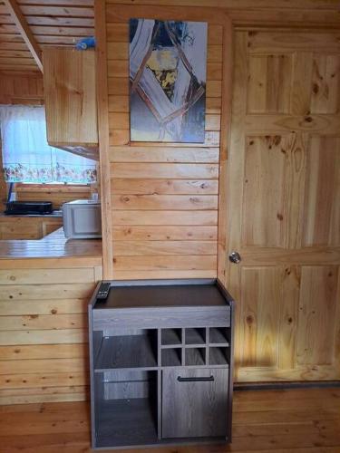 a room with a kitchen with a stove and a door at Cabaña Cebra - THE Spot for GREAT Sunset views! in Jardín