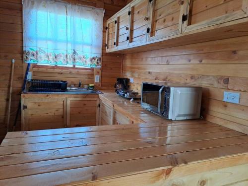 a kitchen with a counter top with a microwave at Cabaña Cebra - THE Spot for GREAT Sunset views! in Jardín