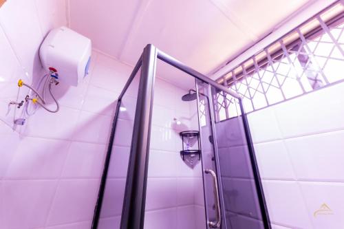 a shower in a bathroom with a glass door at HomeAwayFromHome Villa in Lapaz