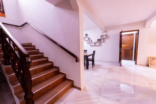 a staircase in a house with a dining room at HomeAwayFromHome Villa in Lapaz