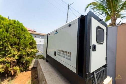 a white trailer on the side of a house at HomeAwayFromHome Villa in Lapaz