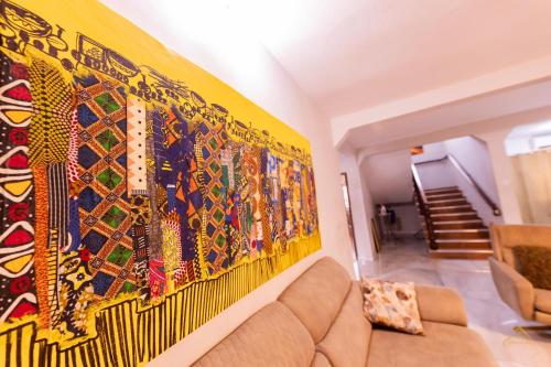 a living room with a large painting on the wall at HomeAwayFromHome Villa in Lapaz