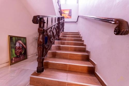a staircase in a house with a wooden stair case at HomeAwayFromHome Villa in Lapaz
