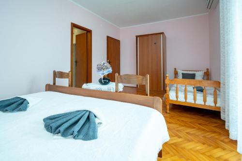 a bedroom with a bed and a table and chairs at Double Room Zubovici 16063a in Zubovići