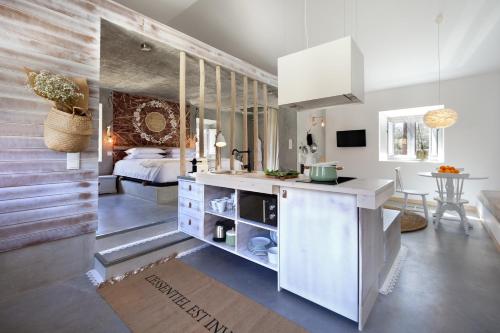 a kitchen with a counter and a bed in a room at Luz Charming Houses in Fátima