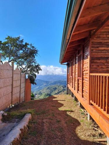 a wooden building with a view of a mountain at Cabaña Gitana - Magical and WINDY nature getaway! in Jardín