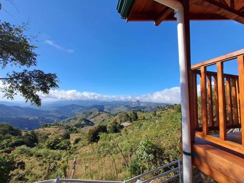 a balcony of a house with a view of the mountains at Cabaña Gitana - Magical and WINDY nature getaway! in Jardín