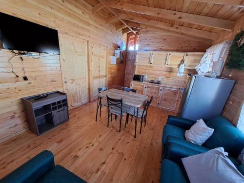 a living room with a table and a blue couch at Cabaña Gitana - Magical and WINDY nature getaway! in Jardín