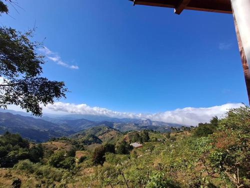 a view of the mountains with clouds in the sky at Cabaña Gitana - Magical and WINDY nature getaway! in Jardín
