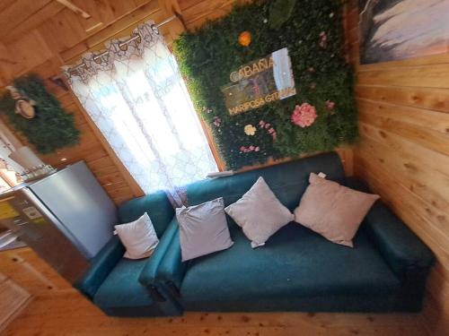 an overhead view of a blue couch with pillows at Cabaña Gitana - Magical and WINDY nature getaway! in Jardín